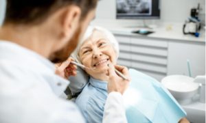 elder woman with dental crown problems