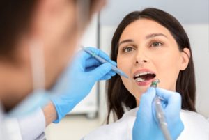 Portrait,Of,Female,Patient,Having,Treatment,At,Dentist,,Close,Up